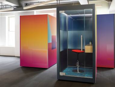 Colorful SnapCab Pods, with a red Coalesse Lox Stool and a wooden Elective Elements Floating Shelf on the inside.