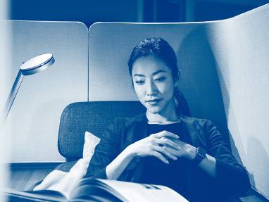 Woman reading, seated on a Brody WorkLounge by Steelcase