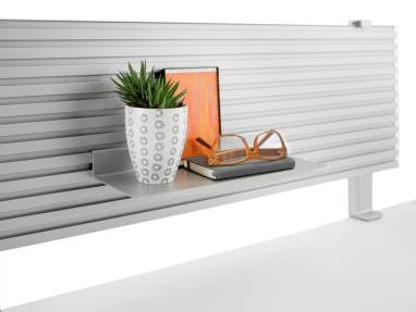 A notebook, glasses and other personal items sit on a small shelf affixed to the slatwall