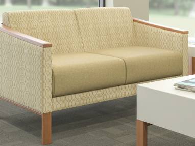Tan Tava Loveseat, Sofa and Single Chairs around a White Coffee Table in a waiting room