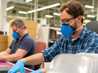 Men working and wearing masks