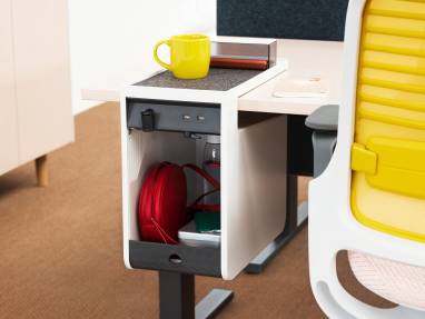 Close up of an open personal console at desk hosting personal belongings