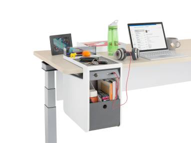 A laptop on a desk attached with a USB charger to a personal console