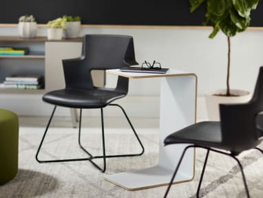 A white Turnstone Campfire Personal Table between two black chairs.