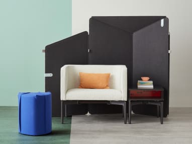 Ancillary space equipped with electric blue Turnstone Campfire Pouf, gray Bivi Rumble Seat and black Bassline Box Top Table surrounded by drak gray Clipper Screen