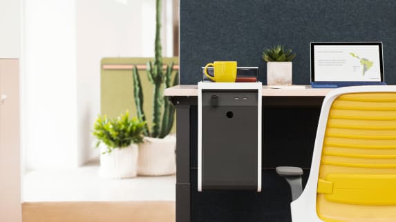 Personal console is seen attached to a work desk