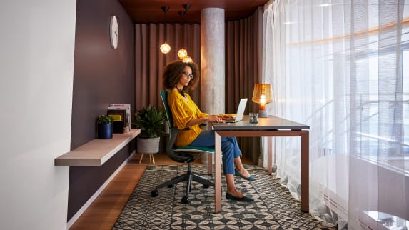 woman sitting on a SILQ in front of a desk