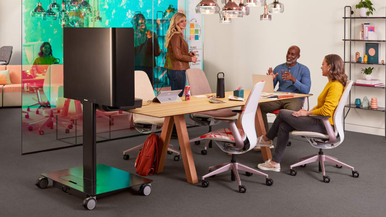 Three people work collaboratively in an open-office collaboration setting furnished with SILQ and Steelcase Flex Mobile Power.
