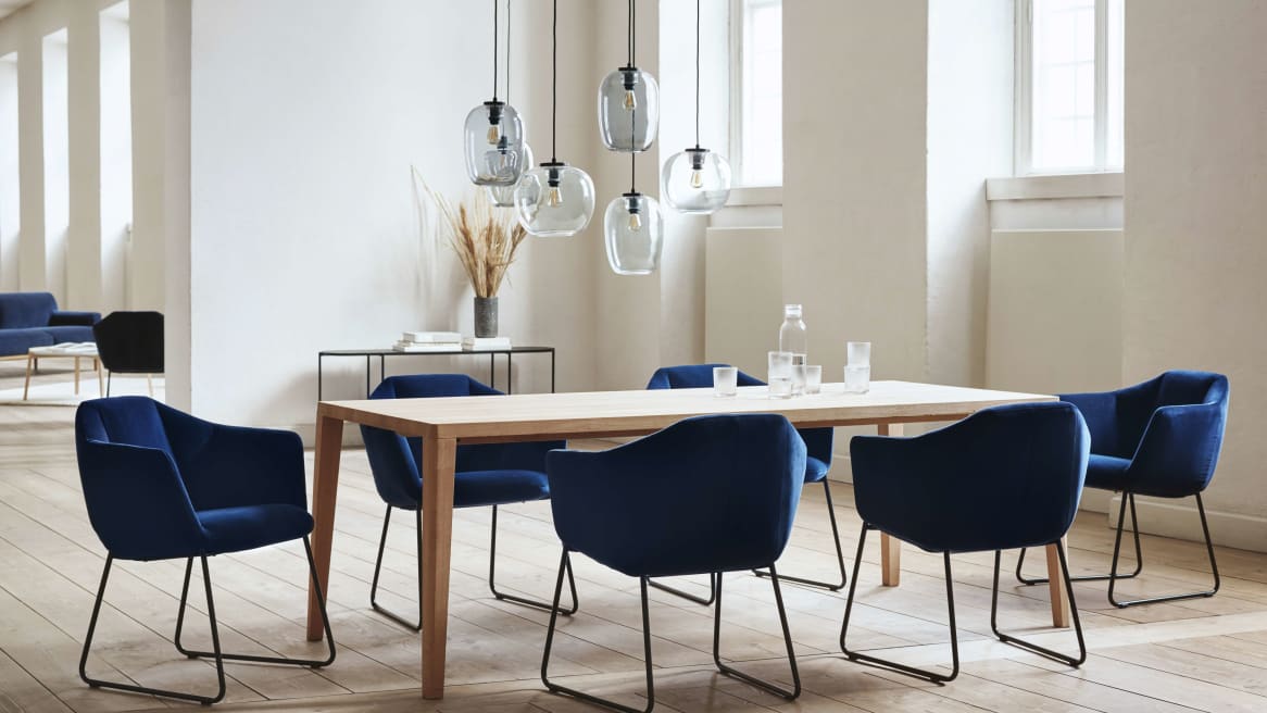Kimono dining chairs in blue around a square table