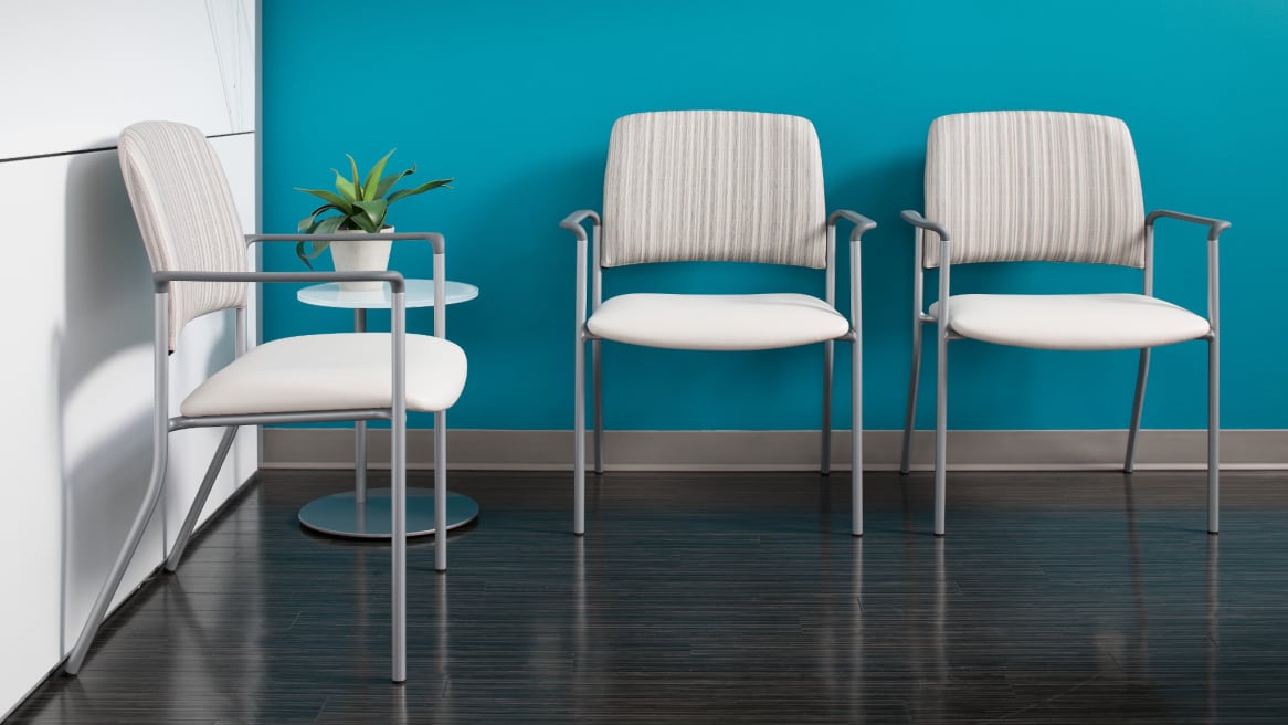 three sorrel chairs with arm rest, small standing table next to them