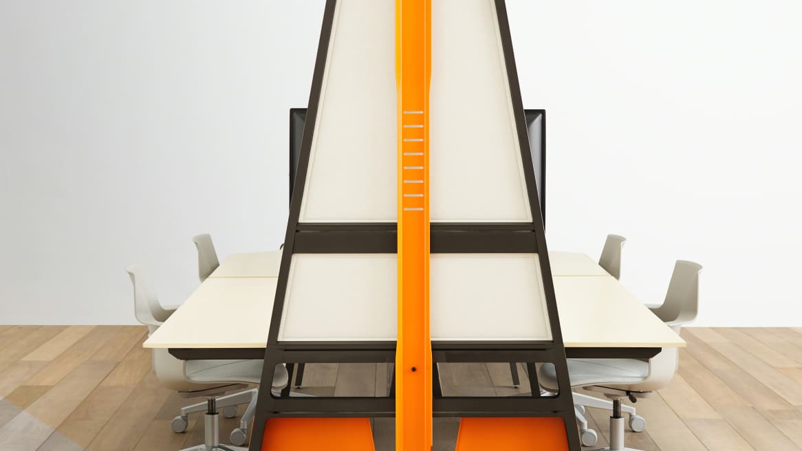 An orange Turnstone Bivi Bike Hook mounted on an orange Turnstone Bivi Team Table surrounded by gray Steelcase Shortcut 5-Star Chairs.
