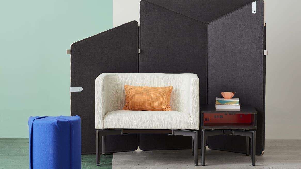 Ancillary space equipped with electric blue Turnstone Campfire Pouf, gray Bivi Rumble Seat and black Bassline Box Top Table surrounded by drak gray Clipper Screen