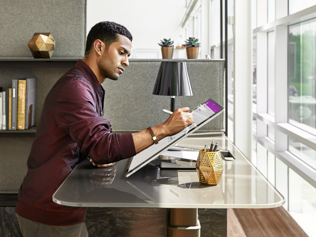 A man works at a Mackinac workstation from Steelcase in a private office setting