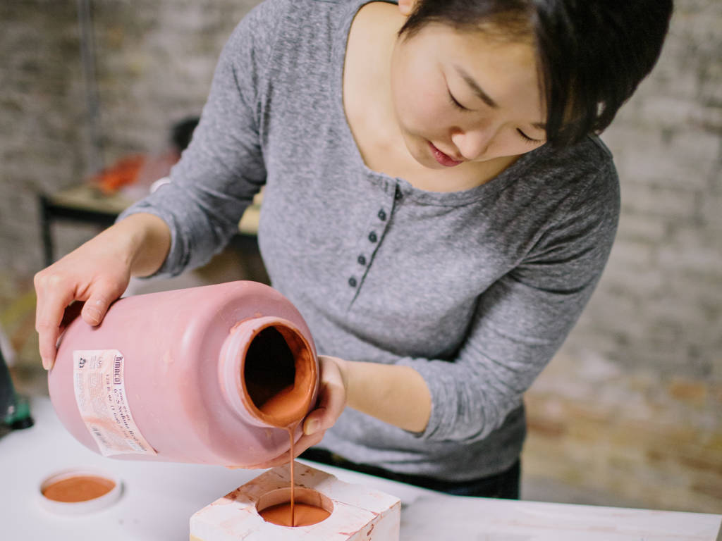 Woman putting clay inside a mold