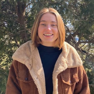 photo of Next participant wearing a jacket and smiling